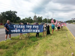 Pensacola State College South End Campus students and faculty stand in the median of Hwy. 98 to honor Sibley as his motorcade drove down the road on the way to Pensacola on Tuesday. (Submitted Photo)