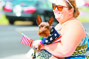 Tyler Morris and her dog Copper came out to show support to the fallen soldier at the foot of the Navarre Beach Bridge.  (Photo by Mat Pellegrino | SSRN) 