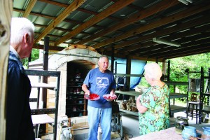 Artist Marty Stokes shows off a few of his pieces of pottery at Holley Hill Pottery. (Photo by Romi White | South Santa Rosa News)