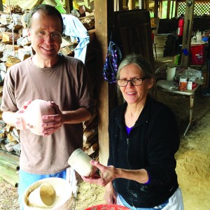 David Morrow of Mobile, Ala. and Maria Spies, who teaches at the Fairhope Arts Center (in Fairhope, Ala.), glaze pots in preparation for the kiln. (Photo by Libbi Crowe | SSRN)