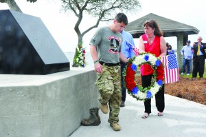 Marine Raider Memorial March founder Nathan Harris helps Leadership Santa Rosa Class 29 member Michele Tucker place a wreath at the foot of the memorial on Friday. (Photo by Mat Pellegrino | South Santa Rosa News)