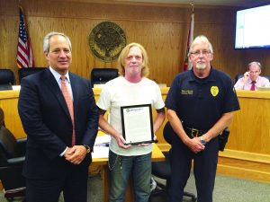 Holmes was presented with a recognition for his efforts at the Monday city council meeting with Mayor Matt Dannheisser (left) and Gulf Breeze Police Chief Robert Randle. (Photo by Mat Pellegrino | South Santa Rosa News(