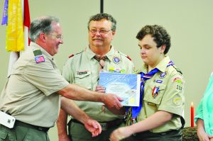 Scoutmaster Joe Gillis congratulates Evan Overly for achieving the rank of Eagle Scout. Overly is pictured with his father, Ralph.  (Photo by Mat Pellegrino | South Santa Rosa News)