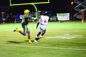 Pensacola Catholic’s Tykies Hestle hits Tristan Covell as he catches long pass down field from Phelps for a 1st and goal in the first half of the game.  (Photo by Christian Graves | South Santa Rosa News)