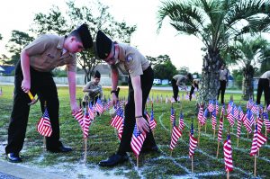 JROTC cadets hammer in the hundreds of American flags for the Sept. 11 ceremony at the high school on Sept. 9. (Photo by Mat Pellegrino | South Santa Rosa News)