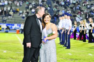Tim Ventura gives his daughter, Mackenzie, a congratulatory kiss after she was selected as the Gulf Breeze High School 2016 Homecoming Queen. (Photo by Mat Pellegrino | South Santa Rosa News) 